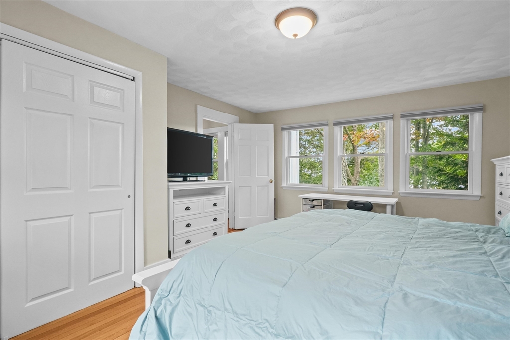 201 Humphrey Street, Unit 2 Marblehead, MA 01945 - Photo 16 of 33 a bedroom with a large bed and a flat tv screen on dresser