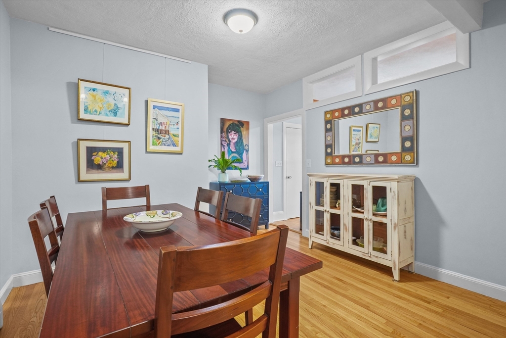 201 Humphrey Street, Unit 2 Marblehead, MA 01945 - Photo 6 of 33 a view of a dining room with furniture wooden floor and a window