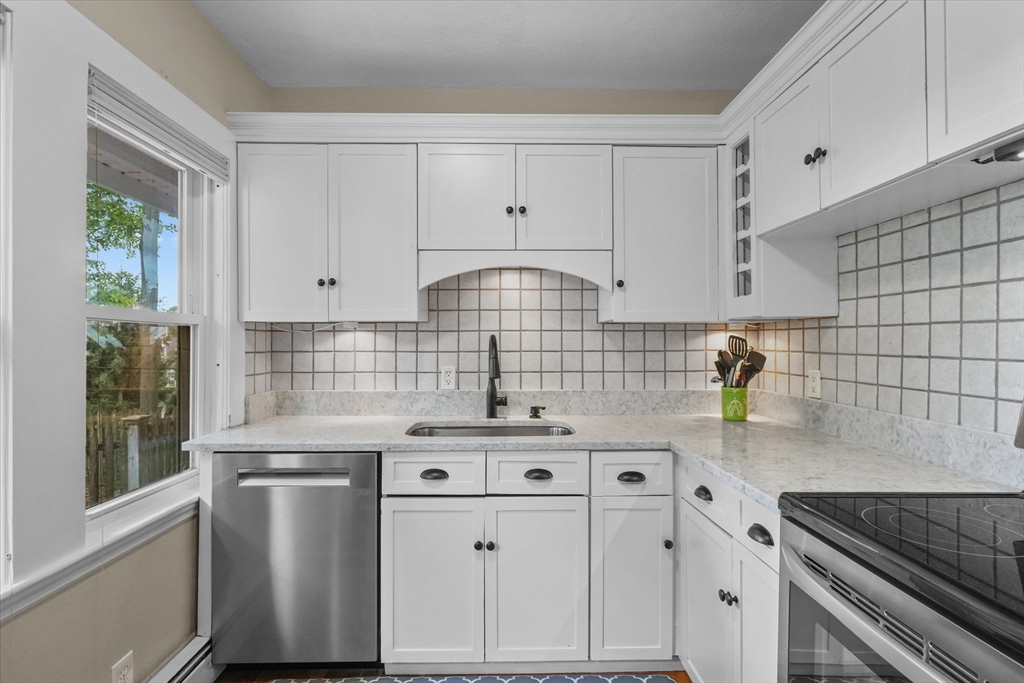 201 Humphrey Street, Unit 2 Marblehead, MA 01945 - Photo 10 of 33 a kitchen with granite countertop a sink a stove and cabinets