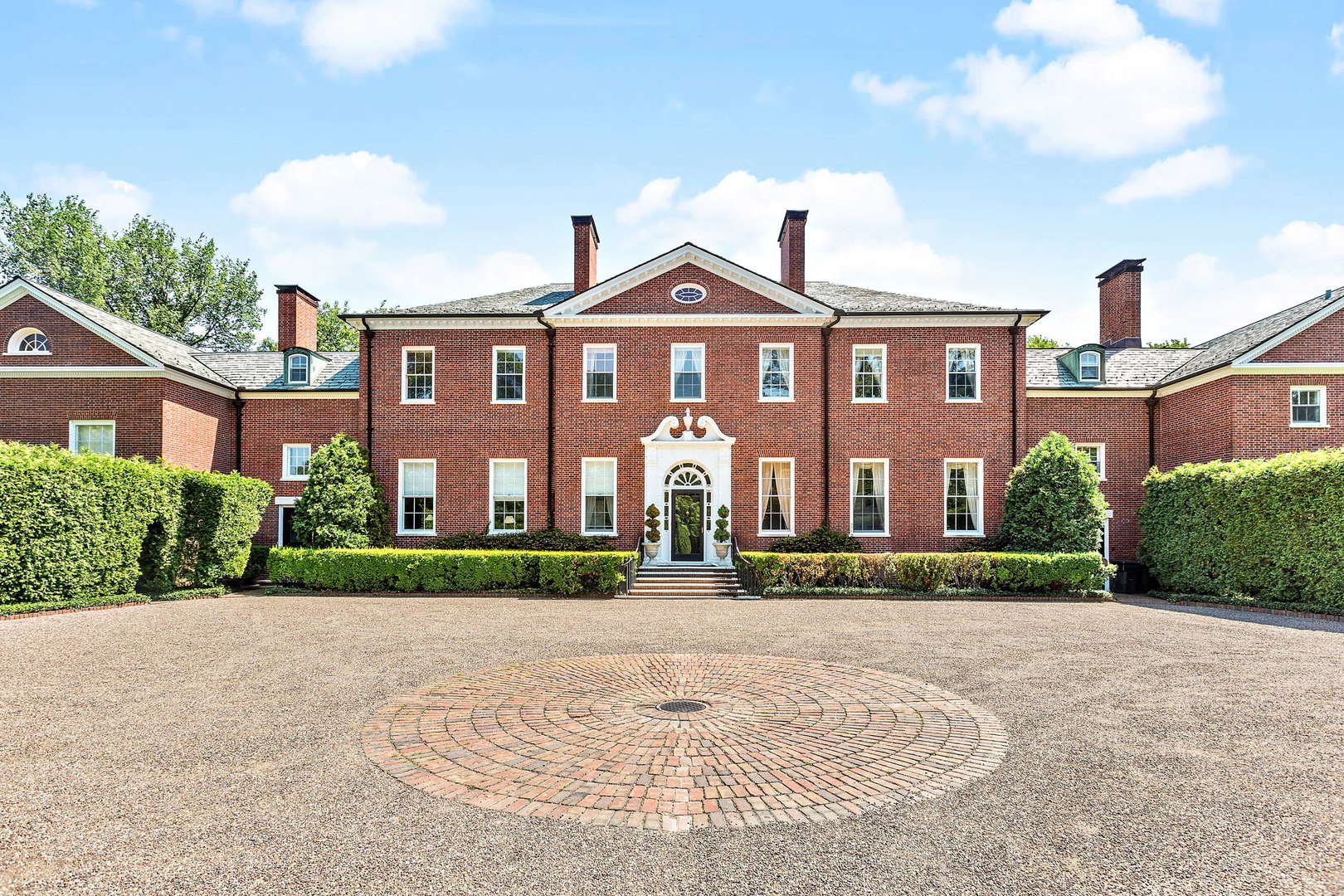 a view of a brick building next to a yard
