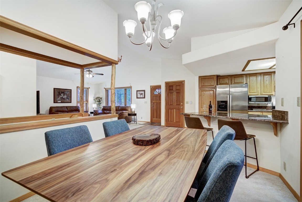 3824 Ski Hill Road Breckenridge, CO 80424 - Photo 13 of 47 a view of a dining room with furniture and a chandelier