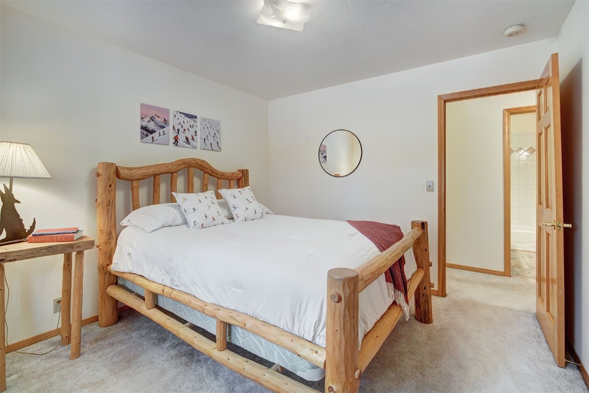 3824 Ski Hill Road Breckenridge, CO 80424 - Photo 23 of 47 a bed room with a bed and a lamp