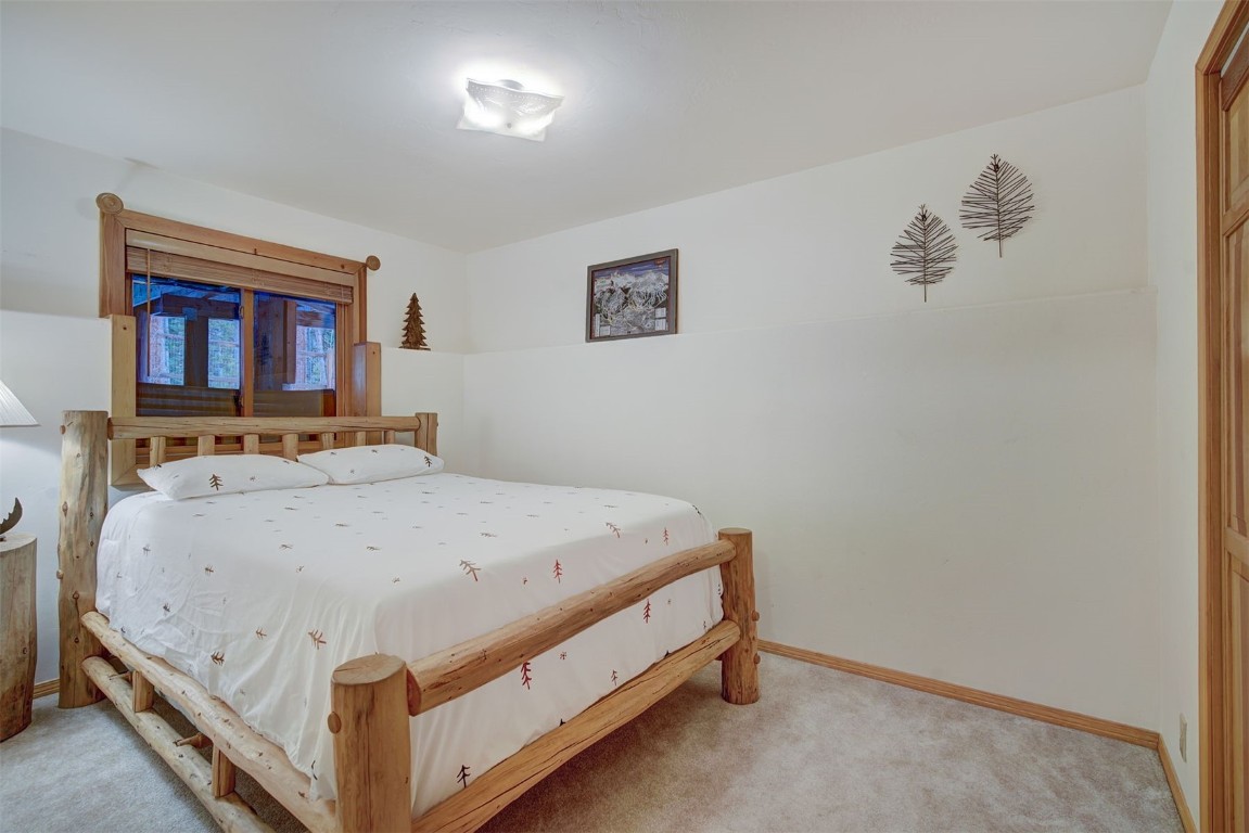 3824 Ski Hill Road Breckenridge, CO 80424 - Photo 26 of 47 a bed sitting in a bedroom next to a window