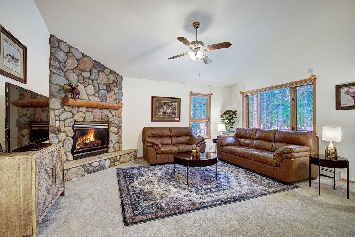 3824 Ski Hill Road Breckenridge, CO 80424 - Photo 6 of 47 a living room with furniture a flat screen tv and a fireplace