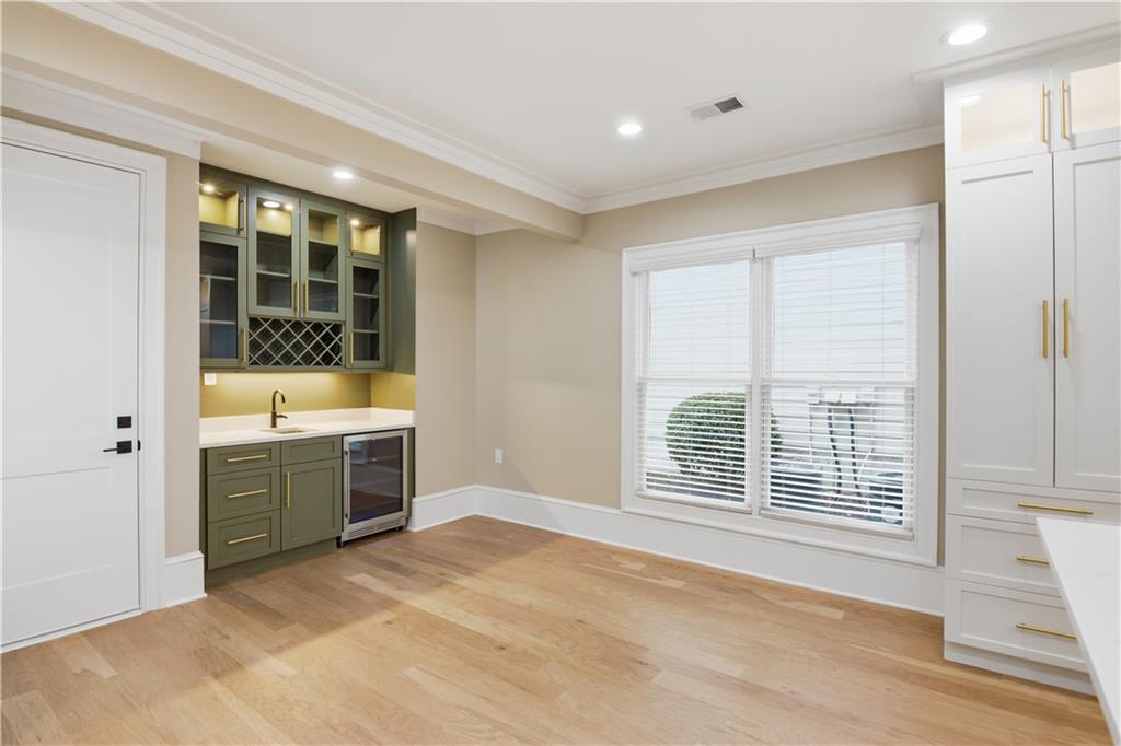 3842 Memphis Drive Suwanee, GA 30024 - Photo 13 of 63 a view of a kitchen with a sink dishwasher and wooden floor
