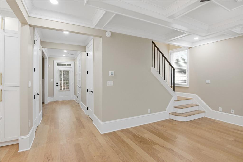 3842 Memphis Drive Suwanee, GA 30024 - Photo 14 of 63 a view of a hallway with wooden floor and staircase