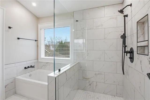 an empty room with a window and a ceiling fan