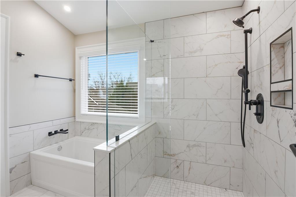 3842 Memphis Drive Suwanee, GA 30024 - Photo 24 of 63 a bathroom with a bathtub and shower