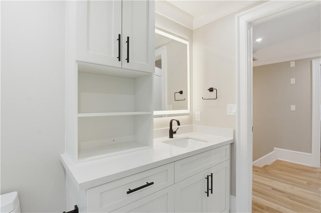 3842 Memphis Drive Suwanee, GA 30024 - Photo 28 of 63 a bathroom with a sink and a mirror