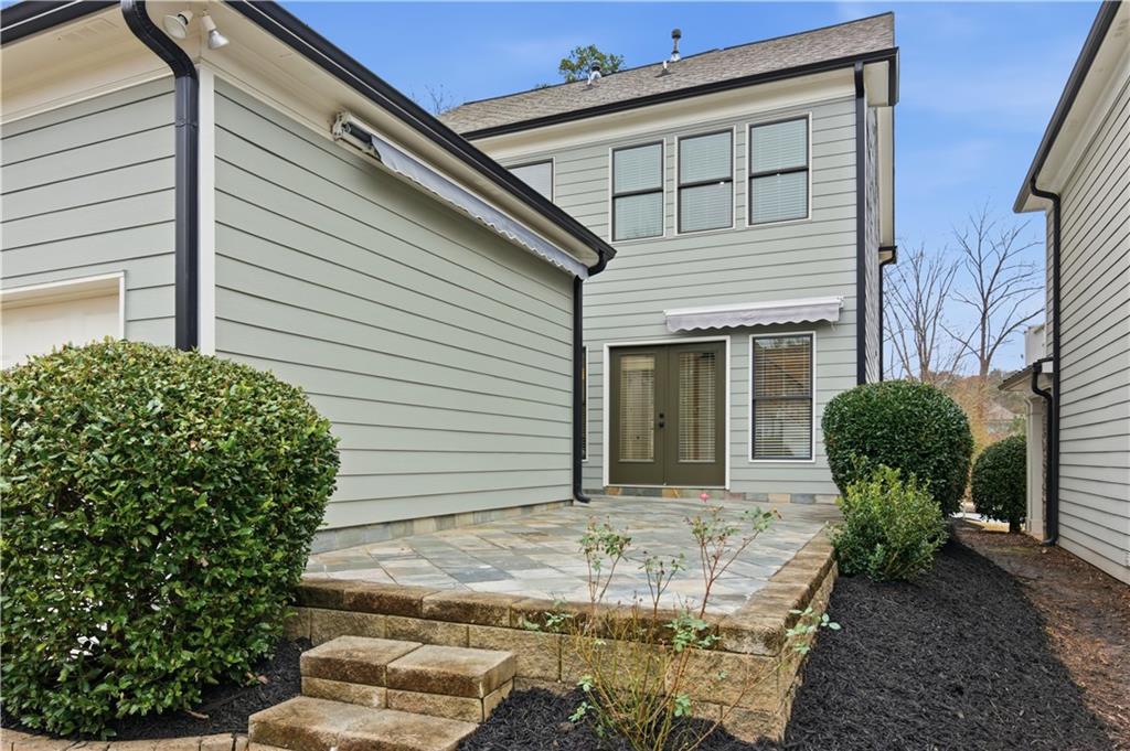 3842 Memphis Drive Suwanee, GA 30024 - Photo 33 of 63 a view of a house with chairs and flower plants