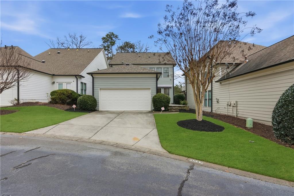 3842 Memphis Drive Suwanee, GA 30024 - Photo 34 of 63 a view of a house with a yard plants and large tree
