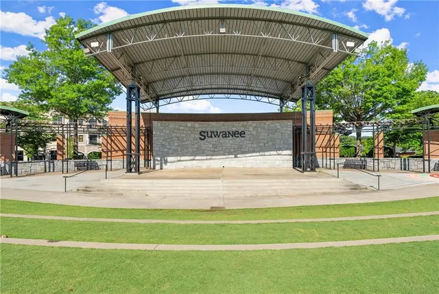a view of a swimming pool with a patio and a garden