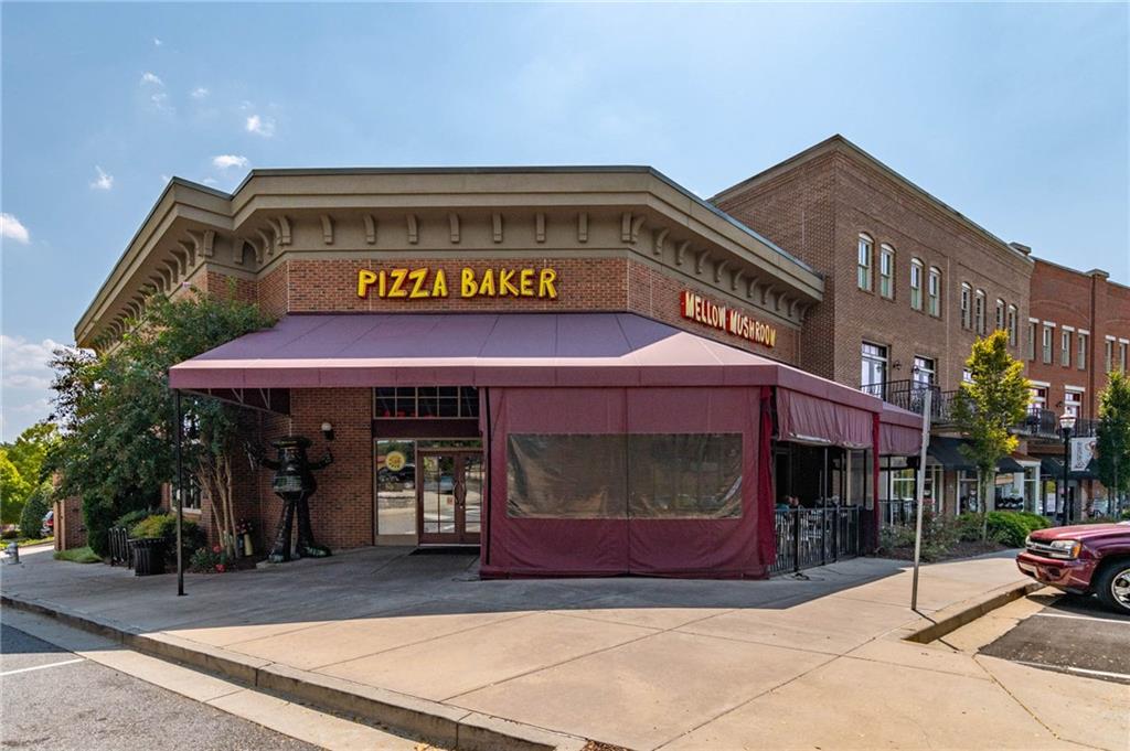 3842 Memphis Drive Suwanee, GA 30024 - Photo 47 of 63 a front view of a building with retail shops
