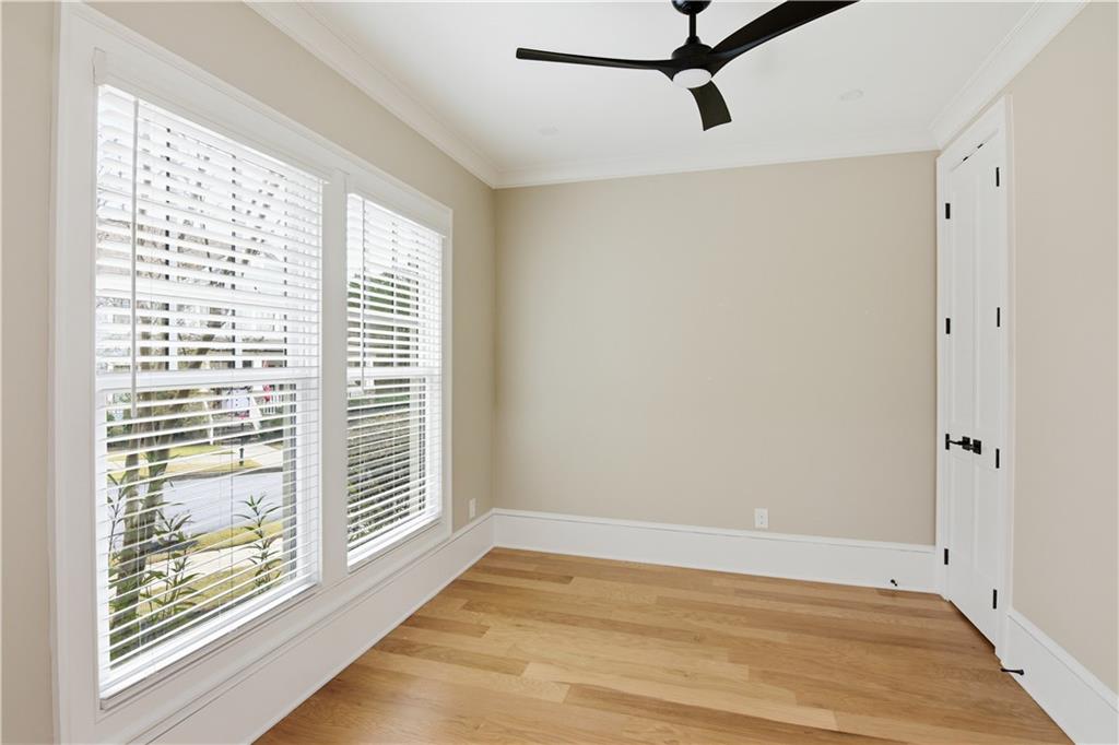 3842 Memphis Drive Suwanee, GA 30024 - Photo 6 of 63 a view of an empty room with a window and wooden floor