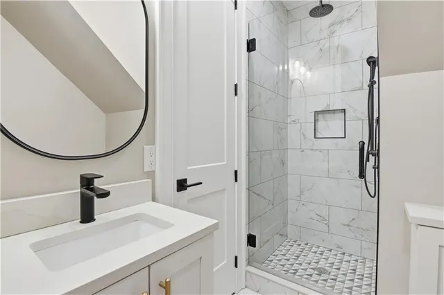 a spacious bathroom with a sink a mirror a vanity and shower