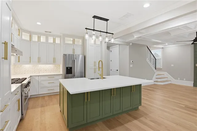 a stove top oven sitting inside of a kitchen