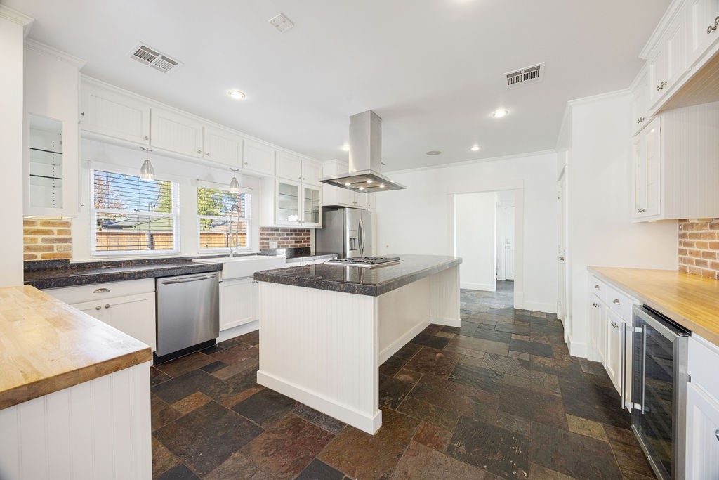 731 Key Street Houston, TX 77009 - Photo 7 of 30 Kitchen is outstanding with a huge island, under cabinet lighting, stainless steel appliances and wine fridge.