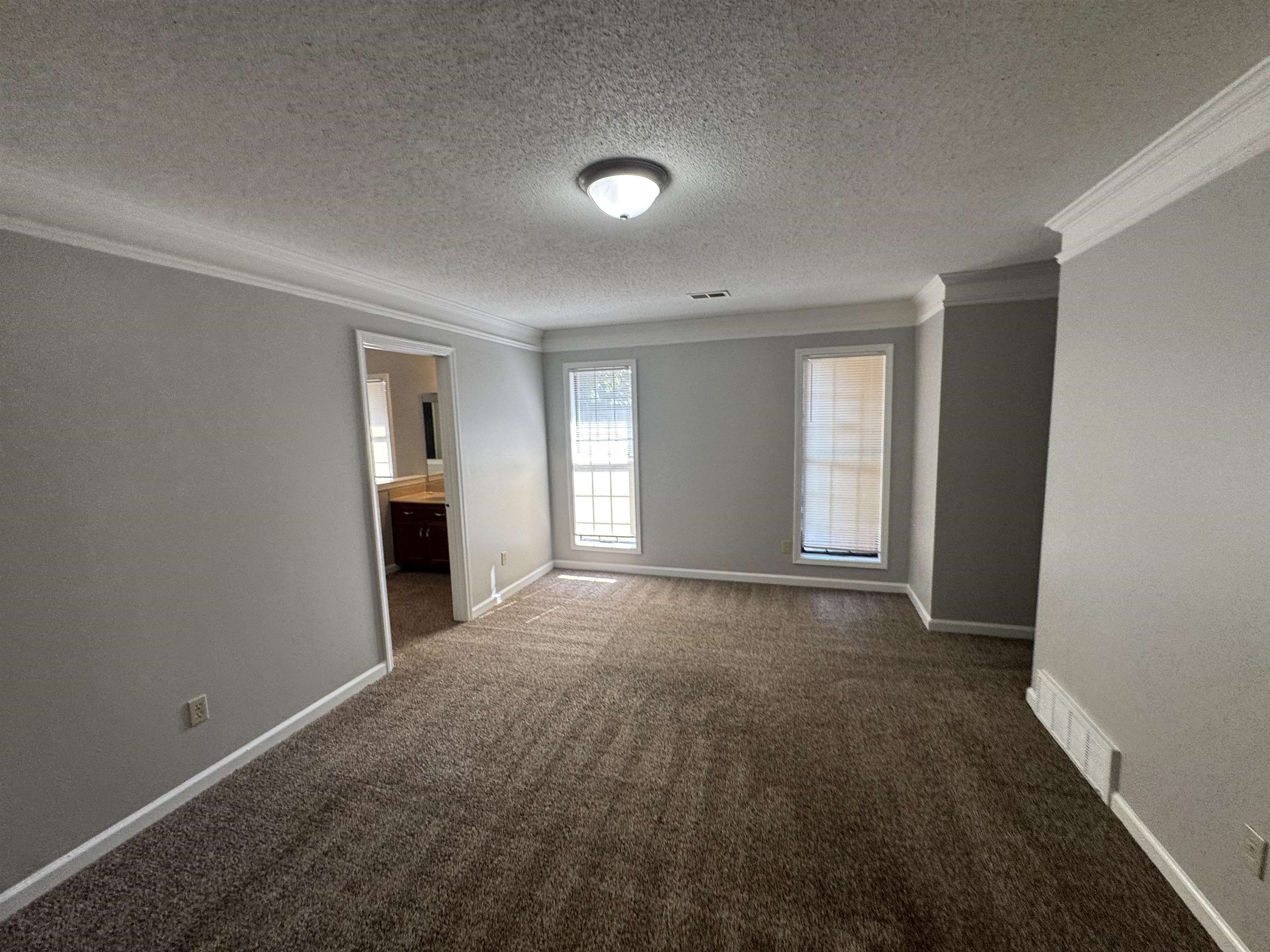 7266 Woodshire Road Memphis, TN 38125 - Photo 10 of 14 Empty room with ornamental molding, carpet floors, and a textured ceiling
