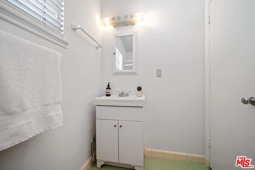 819 East 4th Street, Unit 15 Long Beach, CA 90802 - Photo 15 of 27 a bathroom with a sink a vanity and a toilet