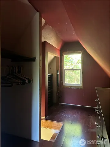 a view of a room with furniture and a window