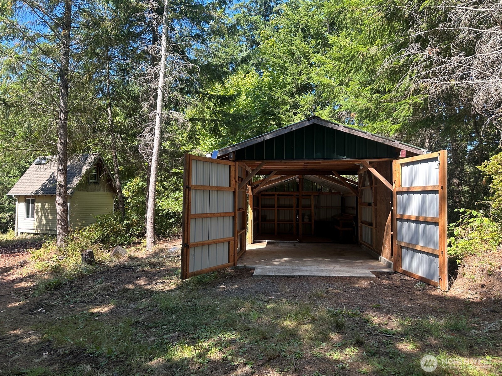 22222-nhn East Quilcene Road Quilcene, WA 98376 - Photo 4 of 39 a front view of a house with a yard