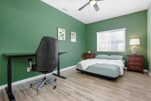 a bedroom with a bed and a chandelier