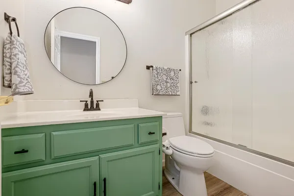 a bathroom with a toilet sink and mirror