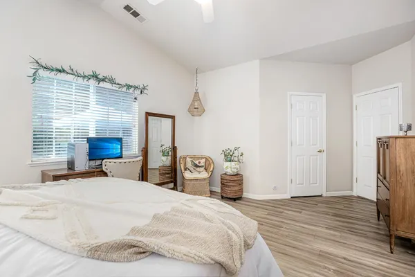 a bedroom with a bed and a large mirror
