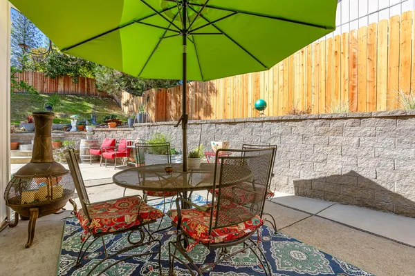 an outdoor space with furniture and umbrella