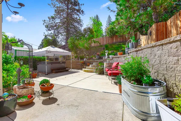 a view of a chair and table in backyard