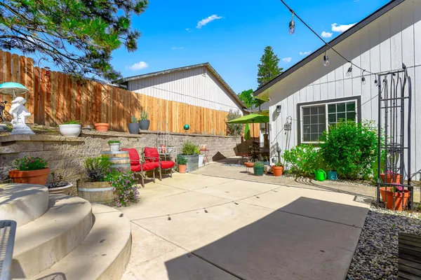 a view of a backyard with sitting area