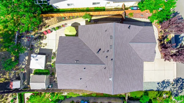 an aerial view of a house with a garden and a yard