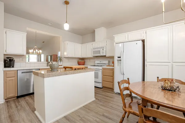a kitchen with refrigerator cabinets and wooden floor