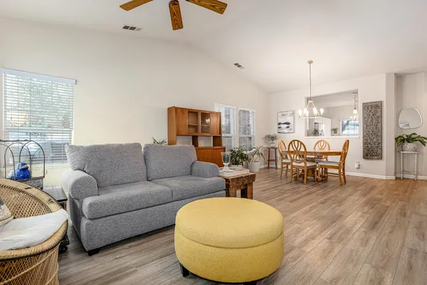 a living room with furniture and a chandelier