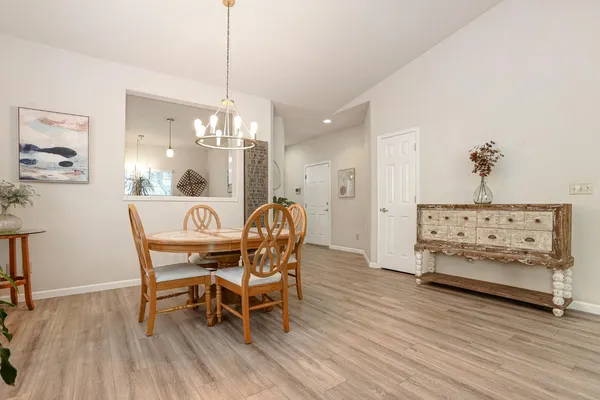 a dining room with furniture and wooden floor