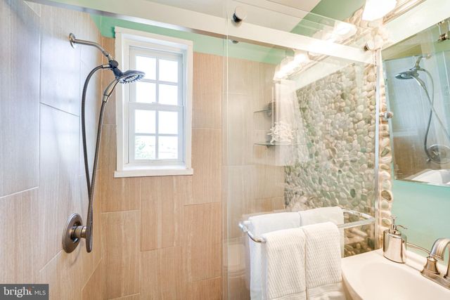 a bathroom with a bathtub and shower