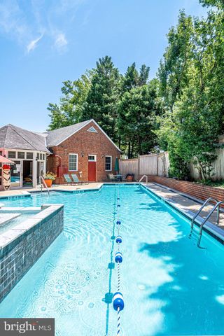 a backyard of a house with large trees and plants