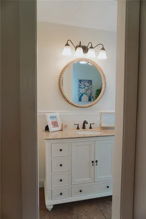 a cabinet with white cabinets and wooden floor