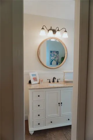 a cabinet with white cabinets and wooden floor