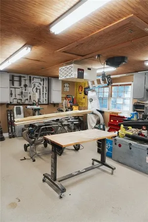 a room with stainless steel appliances kitchen island granite countertop lots of clutter and cabinets