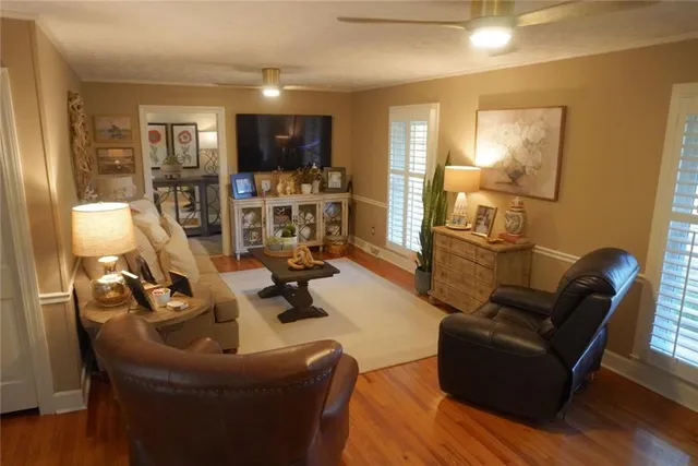 a living room with furniture and wooden floor