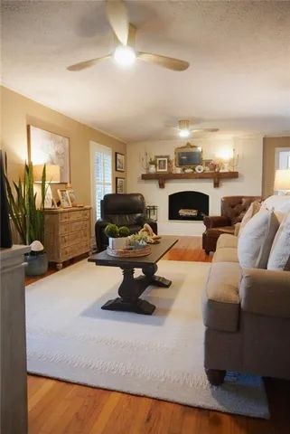 a living room with furniture a fireplace and a flat screen tv