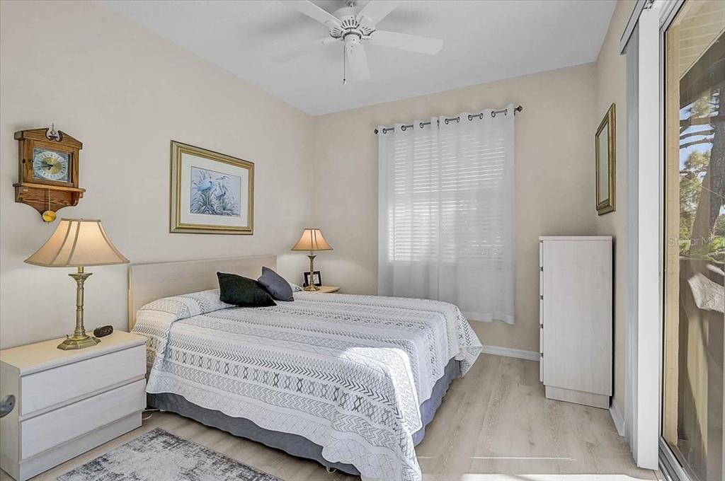 2115 Muskogee Trail Nokomis, FL 34275 - Photo 21 of 39 a bedroom with a bed and a chandelier