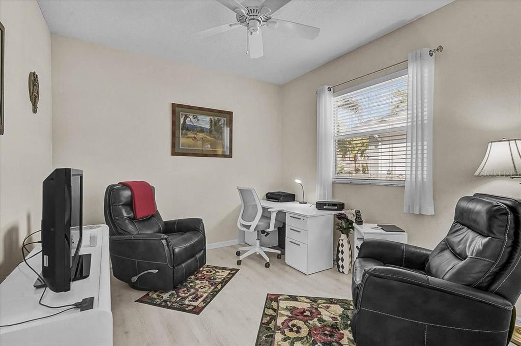 2115 Muskogee Trail Nokomis, FL 34275 - Photo 24 of 39 a living room with furniture a rug and a window