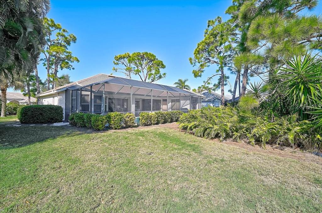 2115 Muskogee Trail Nokomis, FL 34275 - Photo 31 of 39 a view of a front of house with a yard