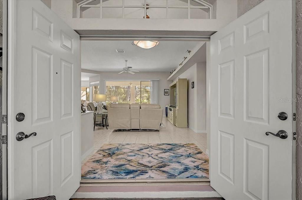 2115 Muskogee Trail Nokomis, FL 34275 - Photo 4 of 39 a view of a hallway to a livingroom and the kitchen view