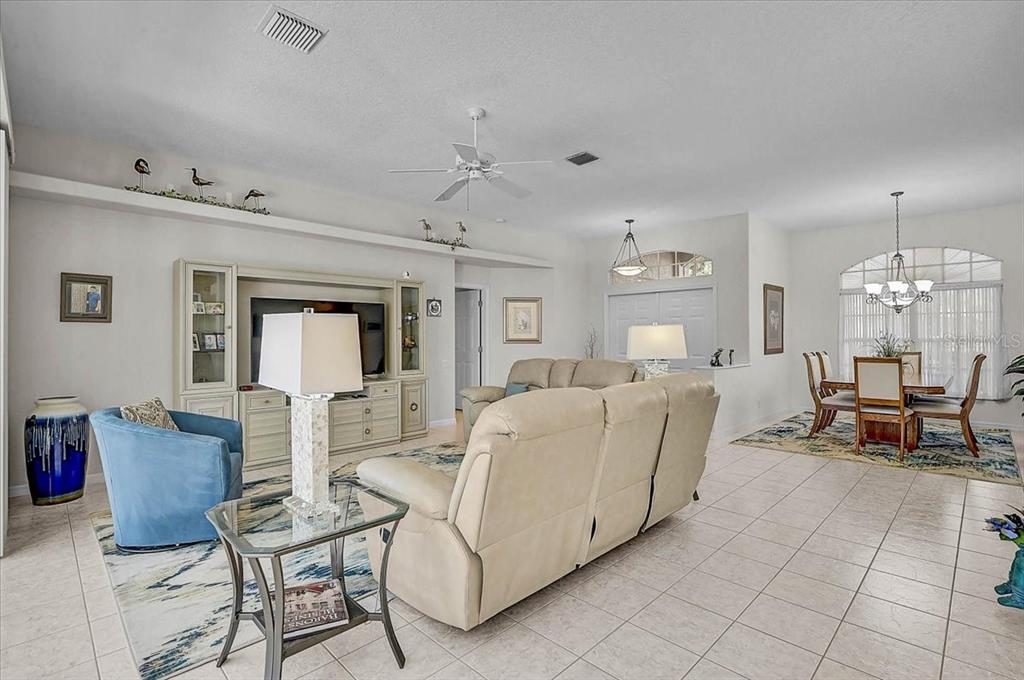 2115 Muskogee Trail Nokomis, FL 34275 - Photo 6 of 39 a living room with furniture and a chandelier
