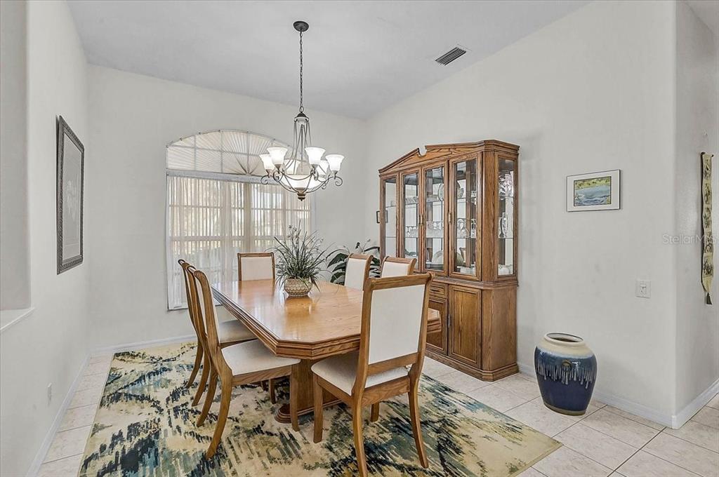 2115 Muskogee Trail Nokomis, FL 34275 - Photo 9 of 39 a view of a dining room with furniture and chandelier