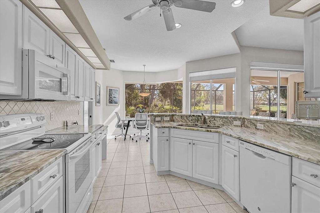 2115 Muskogee Trail Nokomis, FL 34275 - Photo 10 of 39 a kitchen with a sink stove and cabinets