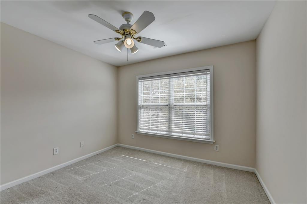 100 Hawnley Trc Northwest Suwanee, GA 30024 - Photo 46 of 58 an empty room with windows and fan